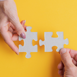 Image of two business men putting puzzle pieces together for finding the right partner header image