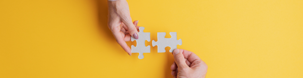 Image of two business men putting puzzle pieces together for finding the right partner header image