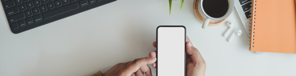 Image of using a mobile phone at work desk