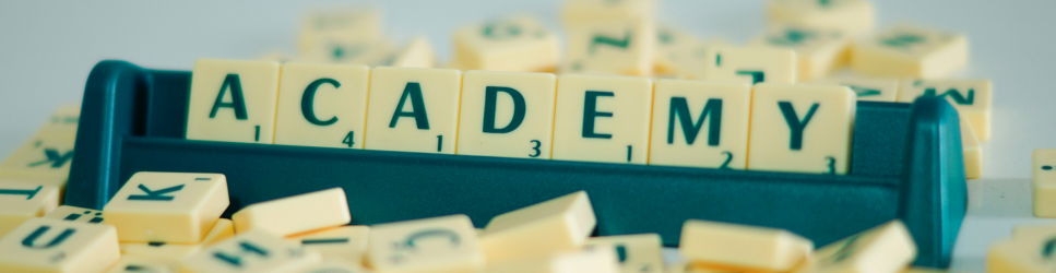 Image of Academy spelt out on scrabble stand