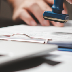 Image of documents being stamped for Immigration act header image