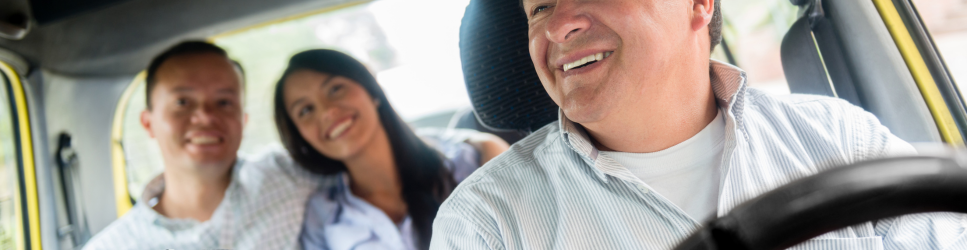 Image of a taxi driver with passengers