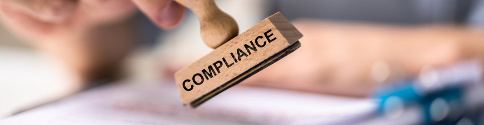 Image of a compliance stamp and documents for article header image