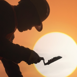 Image of a construction worker laying bricks