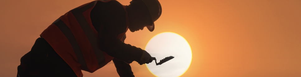 Image of a construction worker laying bricks