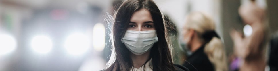 Image of a woman wearing a facemask in a crowd