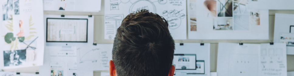 Image of a person inspecting a ideas board for article web header