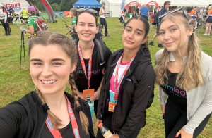 Molly Clapham, Beth Thompson, Juliet Mistry and Casey Williams with their medals after completing the Gower Coast Challenge