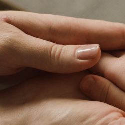 Image of parent holding a child's hand.