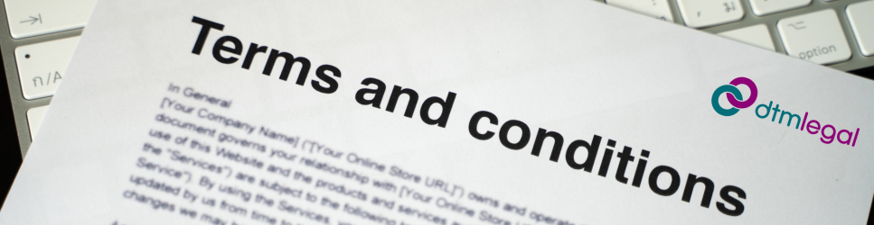 Image of Terms and conditions being held by a keyboard.