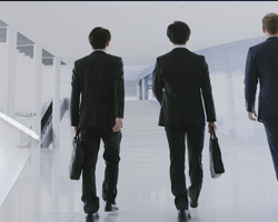 Image of an employer holding Employee Rights Documents with staff in the background