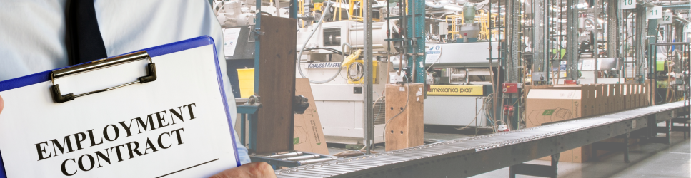 Image of a manager with an employment contract in a manufacturing site.