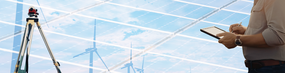 Image of a farmer and land survey equipment with renewable technology in the background for renewable sector page header.