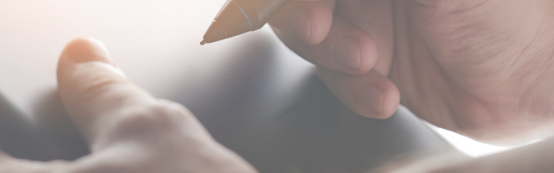 Image of someone signing a digital signature on a tablet