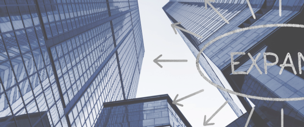 corporate skyscrapers with expansion text overlaid