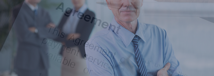 Image of senior leadership staff with an agreement document overlaid