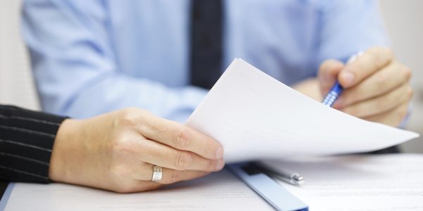 Business people at the office discussing and analyzing document